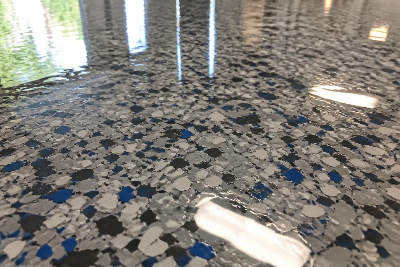 Polyaspartic Coatings floor coating — Clear epoxy topcoat over decorative flake floor with wet-look gloss