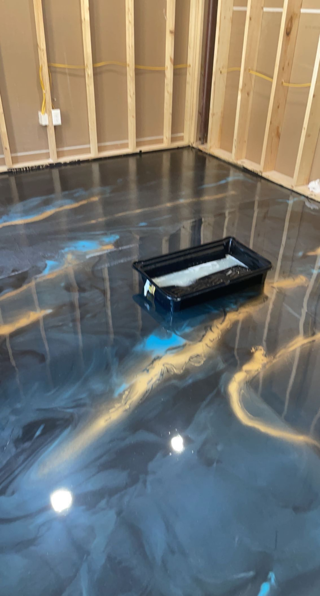 Finished floor: New Build Metallic Pour — Blue, gold and charcoal metallic epoxy floor poured in a new build